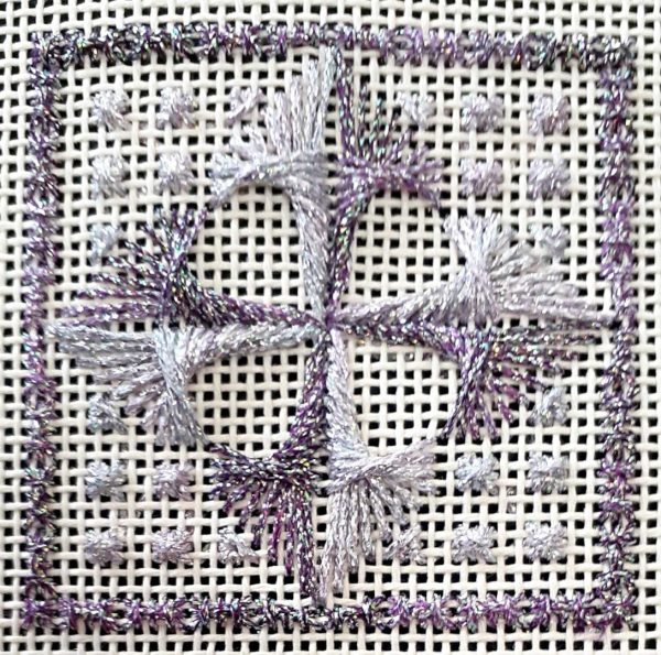 A photo of an embroidered square in a square.