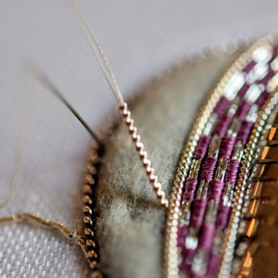 close-up photo of in-progress embroidery with metal threads