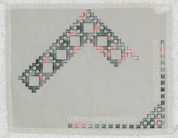 photo of embroidery made if stitches counted and grouped to form patterns on an even-weave fabric
