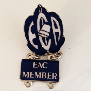 Enamel pin with the EAC shield logo and a second pin below with "EAC Member" text
