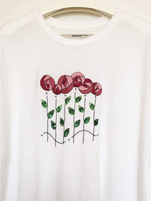 photo of the front of a t-shirt with embroidered stylized roses