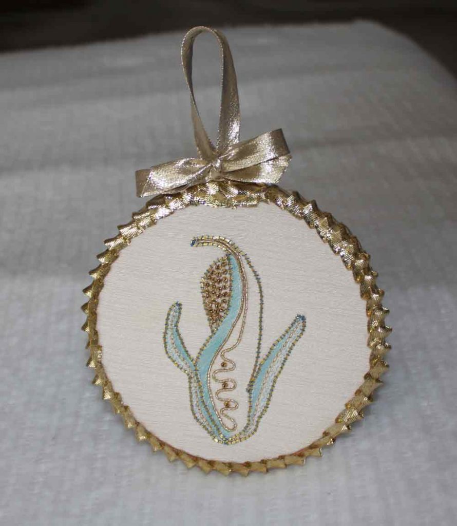 photo of an embroidered, blue and white cob of corn