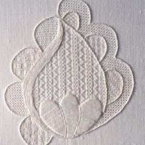 photo of an embroidered a flower bud formed in white textured embroidery