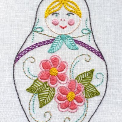 photo of an embroidered Matryoshka doll with flowers on her body