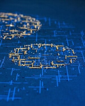 photo of golden circles embroidered onto blue fabric