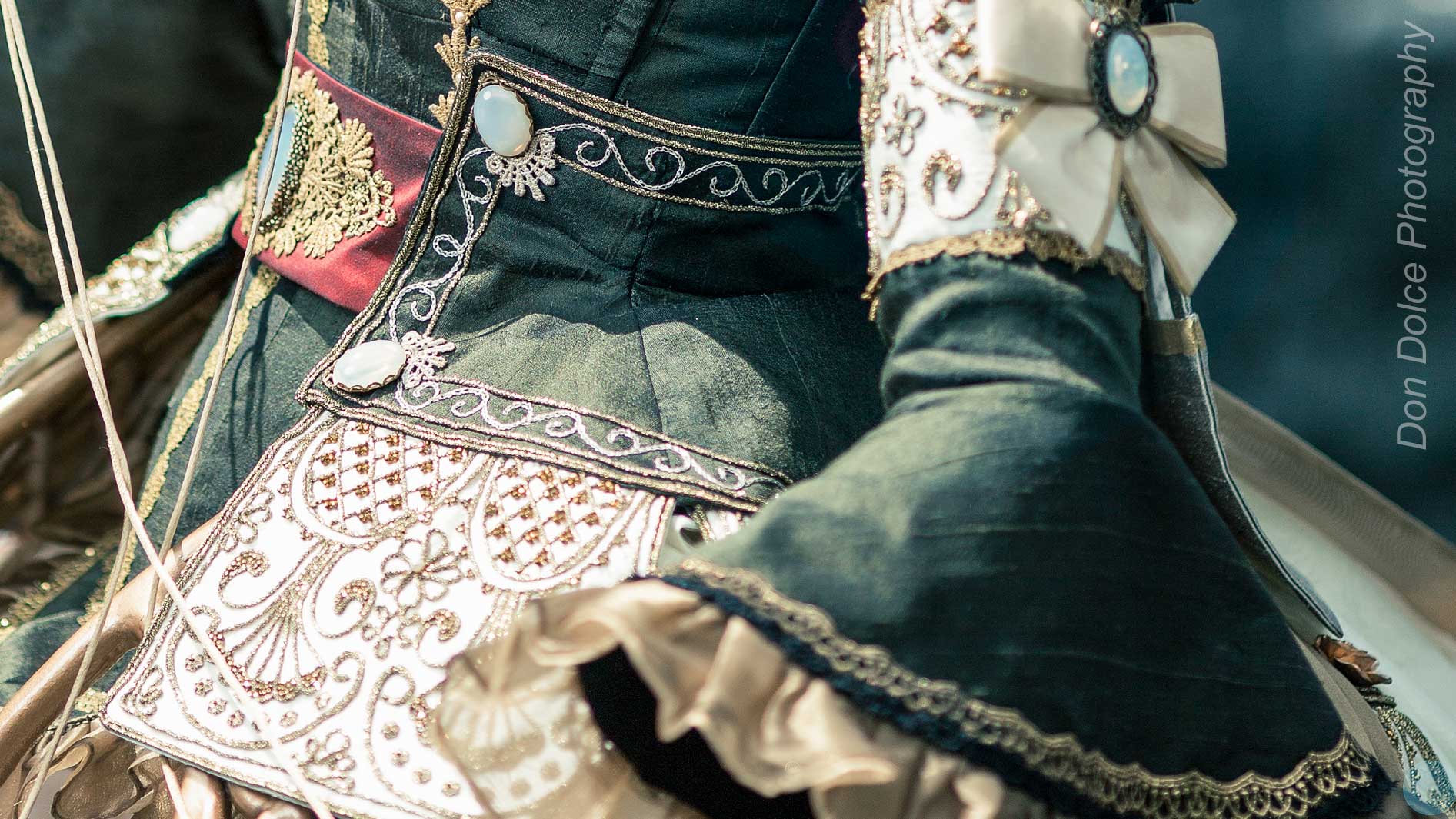 Details of the embroidery on the bodice and leaves of a green cosplay dress. Photo © Don Dolce Photography.