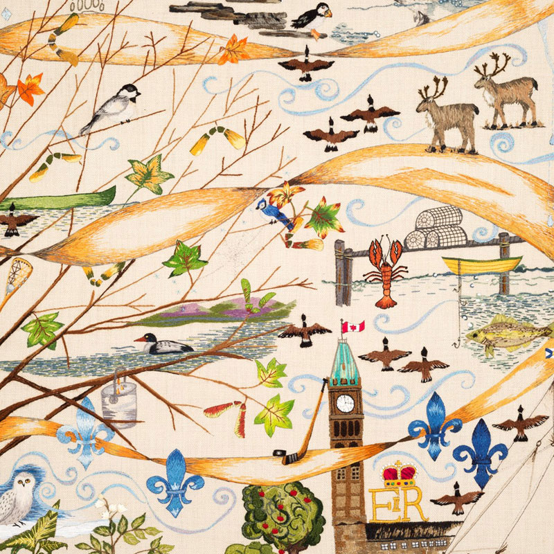 Photo of a small portion of an embroidery with caribou, Canada geese, a puffin. lobster, fishing boats, Canadian Parliment buildings, a snowy owl, fleur-de-lys, and other eastern-Canadian icons.