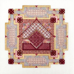 Photo of a square embroidery with stitching on a grid to form shapes and patterns in a variety of colours.