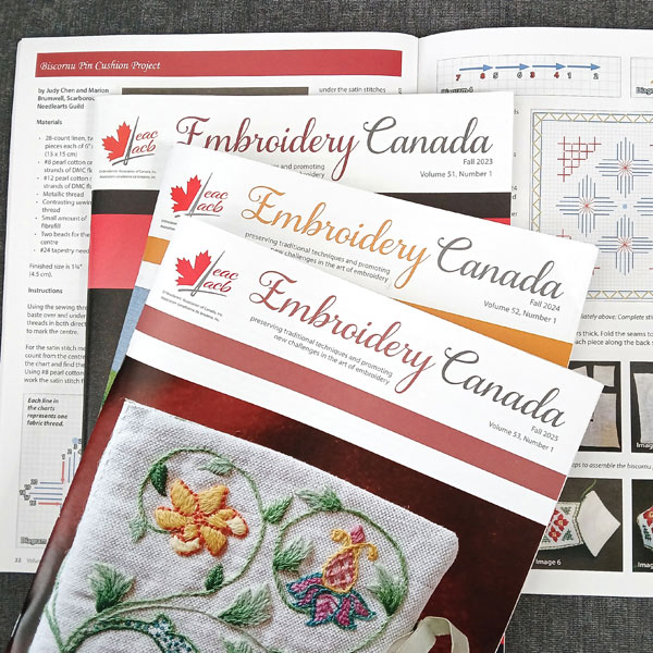 Photo of three Embroidery Canada magazines on an opened issue.