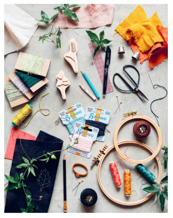 A photo of embroidery supplies spread on a surface.