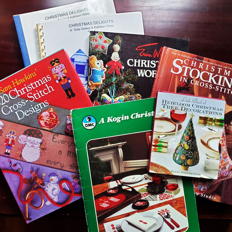 Photo of a fanned out display of Christmas-themed embroidery books.