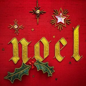 Photo of a dimensional embroidery with the word "Noel," two stumpwork holly leaves, three berries and three goldwork stars with crystal centres.