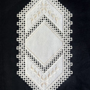 White geometric-shaped Hardanger table runner with Smyrna stitches, satin stitches and lacy buttonhole edging.