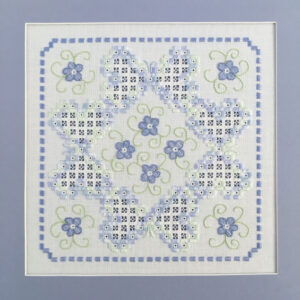 Purple-blue flowers are in the center and corners, while openwork and eyelet butterflies adorn the fabric. Beautiful hem-stitching in the same purple-blue thread surrounds the design area.